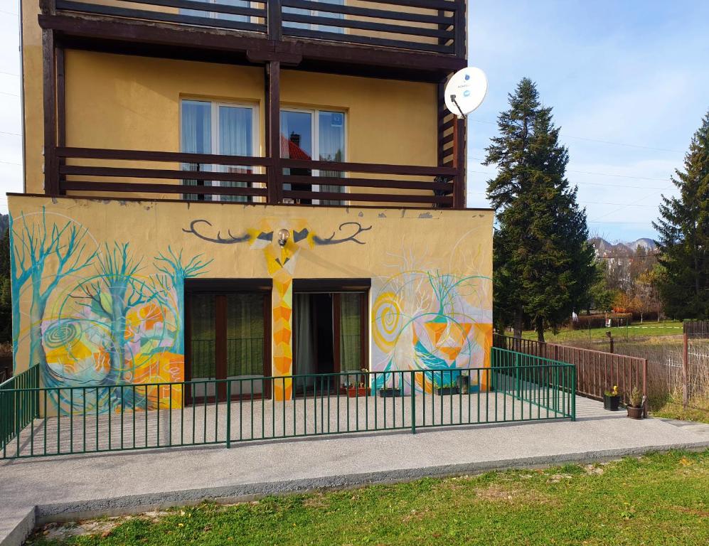 a building with a painting on the side of it at Happy Holiday Apartments in Predeal