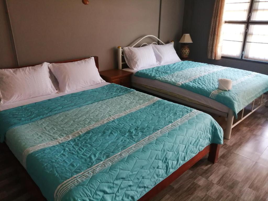Postel nebo postele na pokoji v ubytování Yotin Guest House