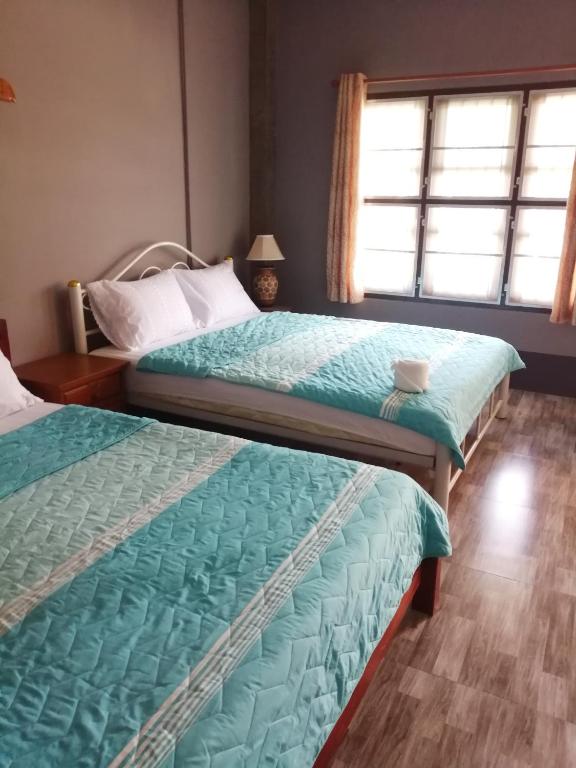 Postel nebo postele na pokoji v ubytování Yotin Guest House