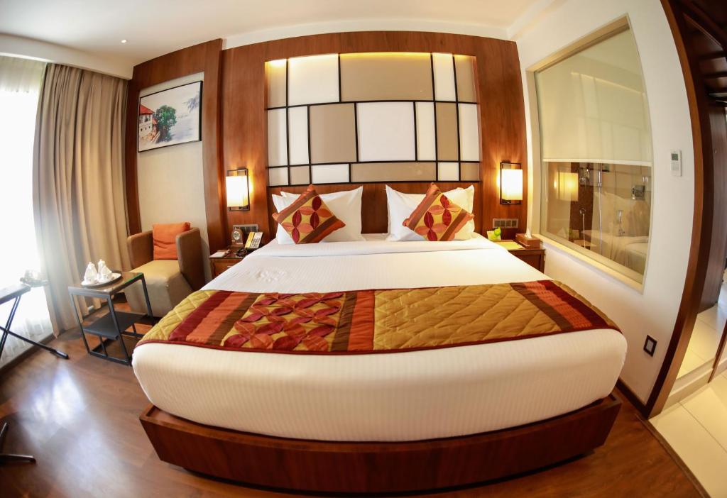 a bedroom with a large bed in a room at Hotel Span International in Cochin