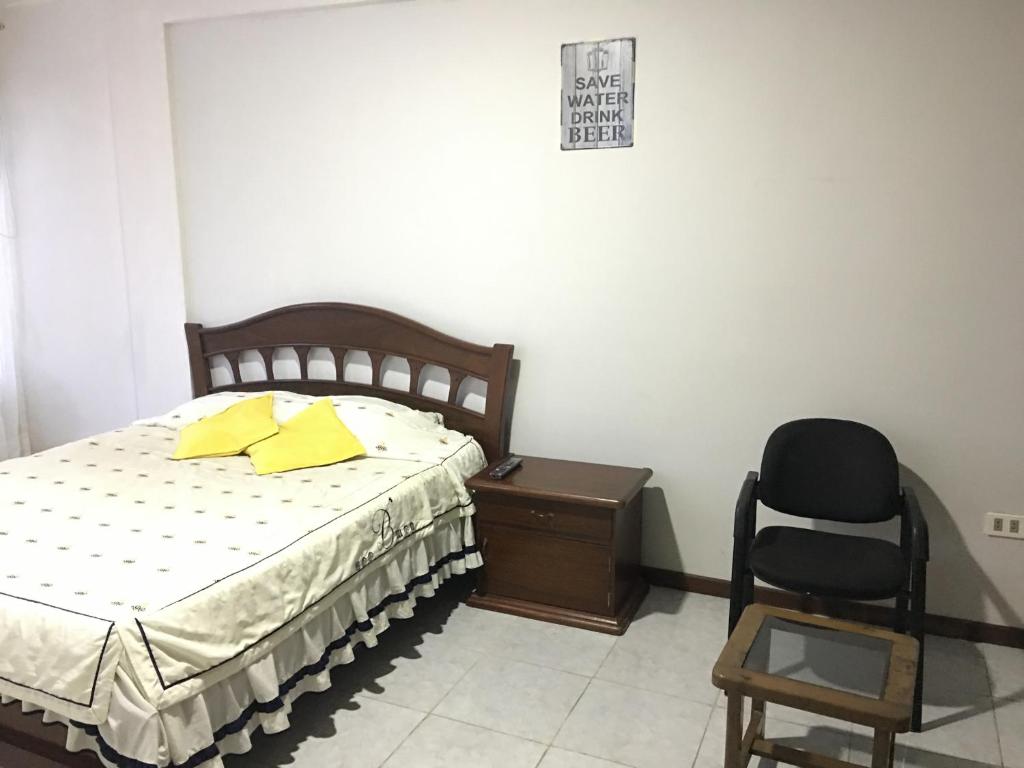 a bedroom with a bed and a chair and a desk at Safety and Comfort in Santa Cruz de la Sierra