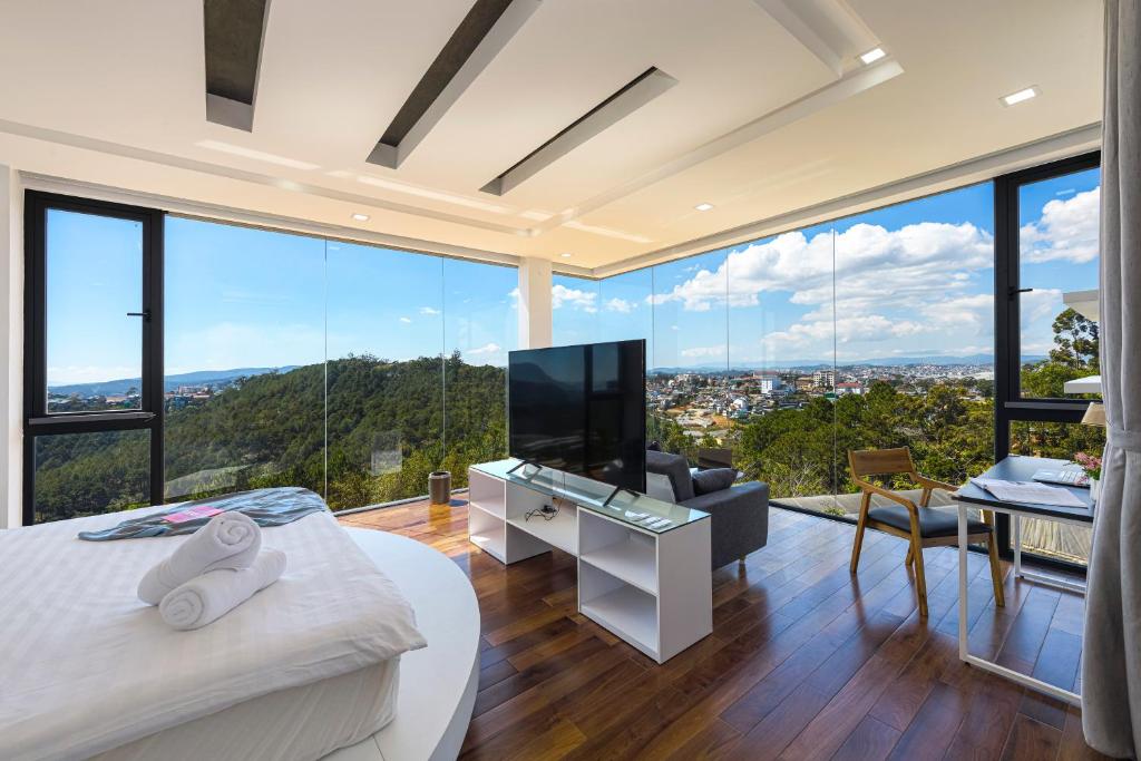 a living room with a large window view of a city at Q&P Smart Ville in Da Lat