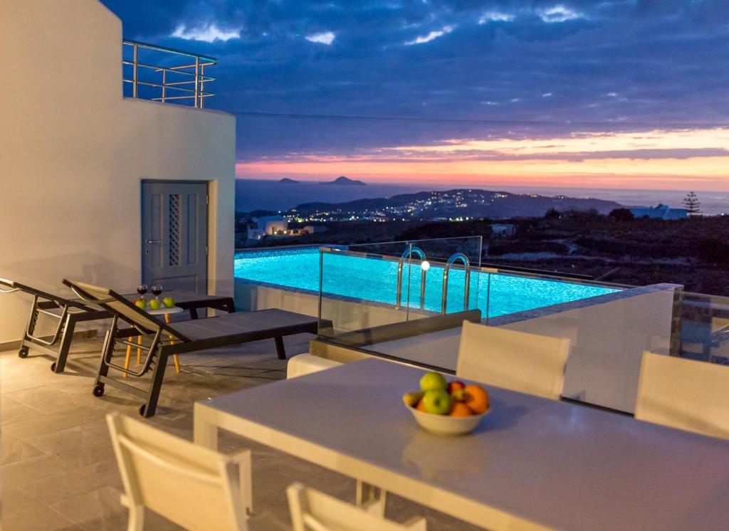 un tavolo con un cesto di frutta in cima a una casa di Luxe Maroussi Villas a Pyrgos