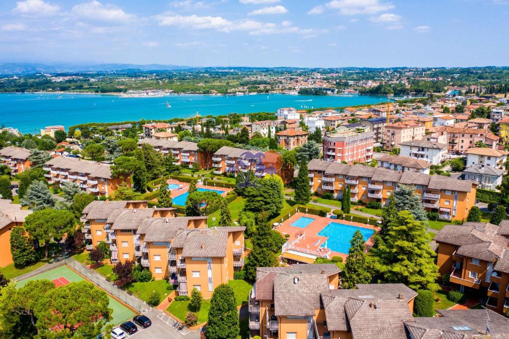 an aerial view of a residential estate with a swimming pool at Premium Apartments Peschiera in Peschiera del Garda