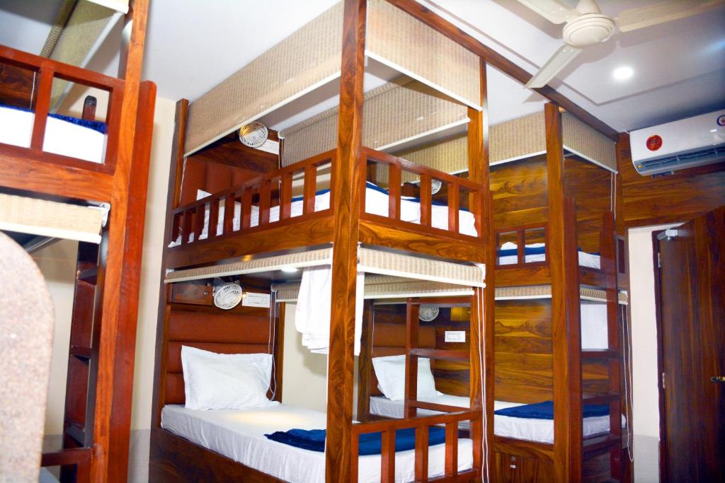a bunk bed room with three bunk beds at Hotel Nest N Rest - Mumbai in Mumbai