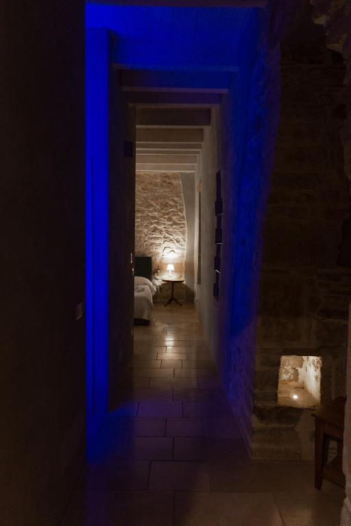 a dark hallway with blue lights in a room at Graffiti Living - Santa Rita - Rooms in Corato