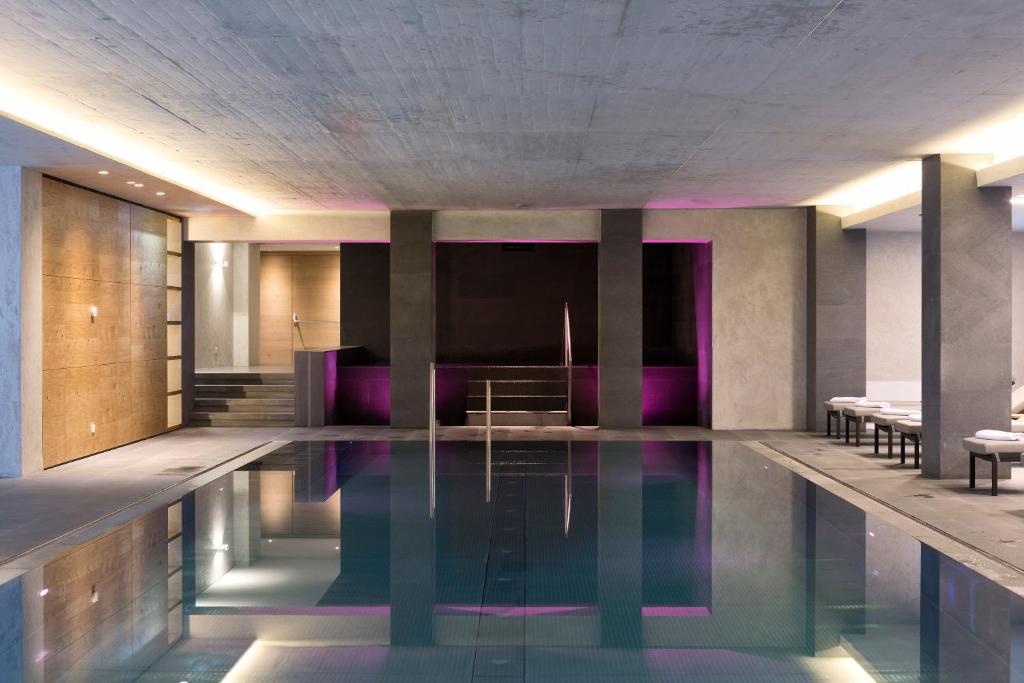 a swimming pool in a building with purple lighting at ElisabethHotel Premium Private Retreat- Adults only in Mayrhofen