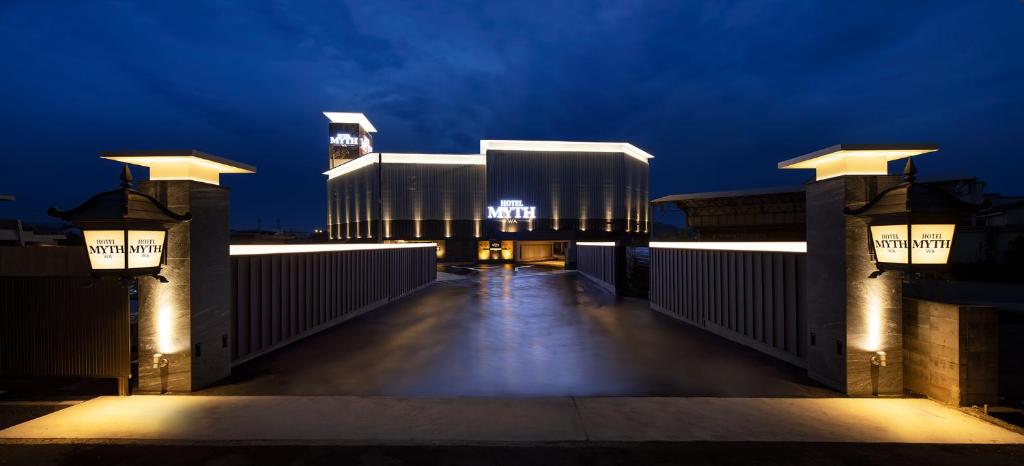 a large building with lights on it at night at HOTEL MYTH-WA -ホテル マイス ワ- adult only in Wakayama