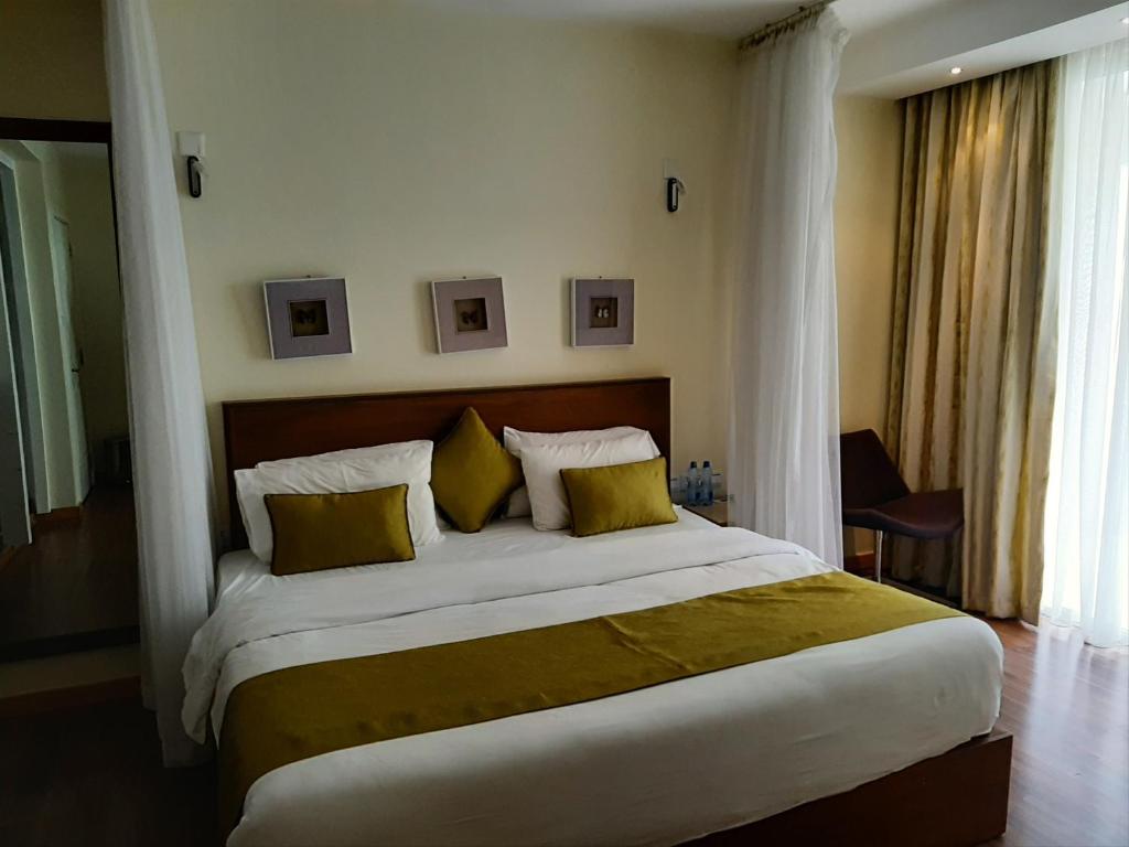 Postel nebo postele na pokoji v ubytování D2W Residency Suites