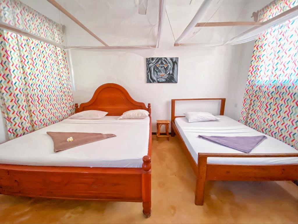 Postel nebo postele na pokoji v ubytování Papaya Guest House Nungwi