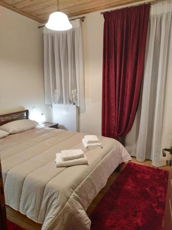 a bedroom with a bed with two towels on it at Tzelati Vytinas in Vitina