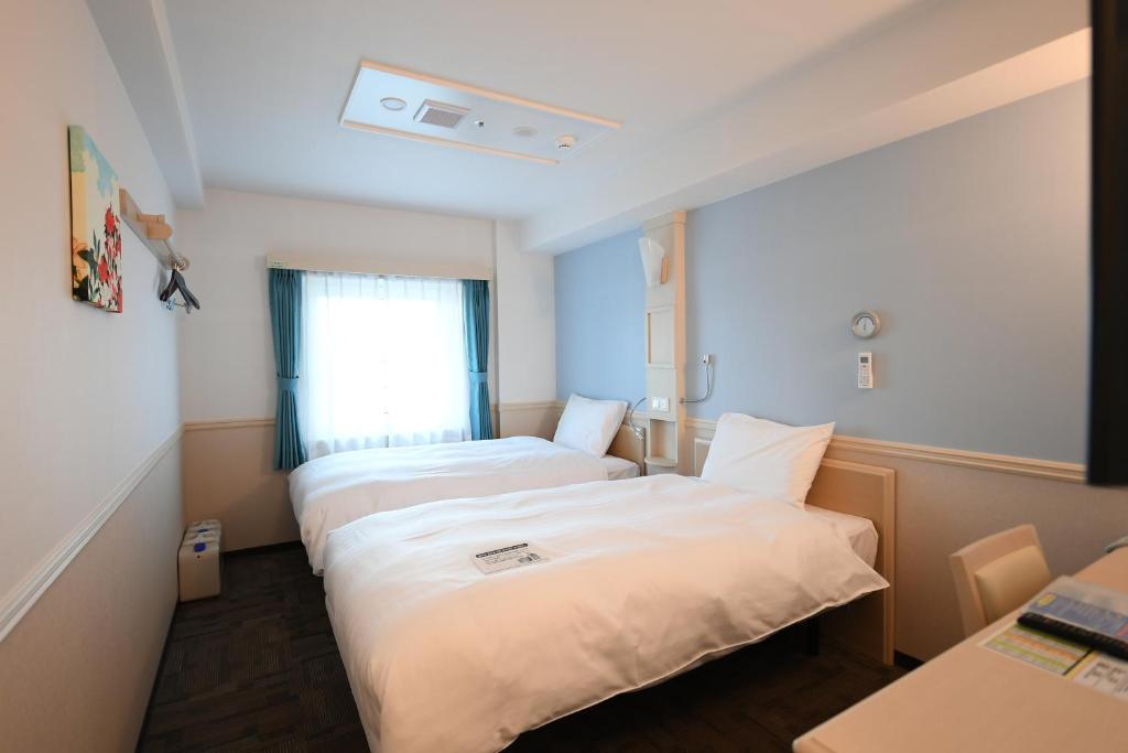 Postel nebo postele na pokoji v ubytování Toyoko Inn Ulsan Samsan