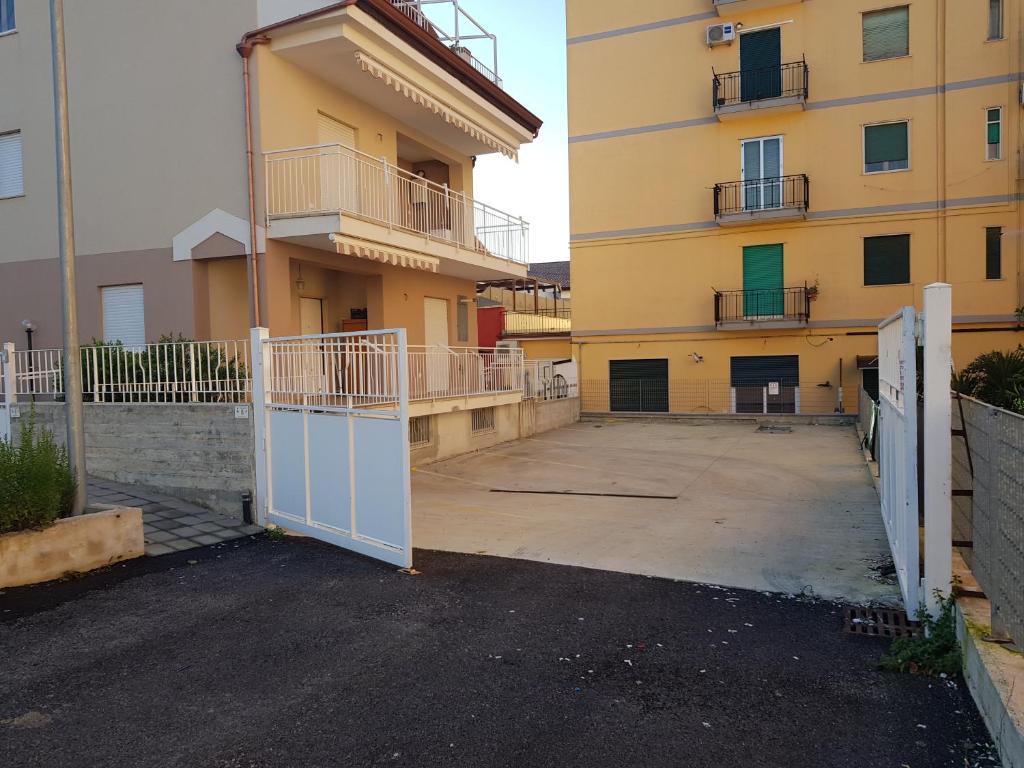 an empty parking lot in front of a building at San Marco Beach App Libeccio in Agropoli