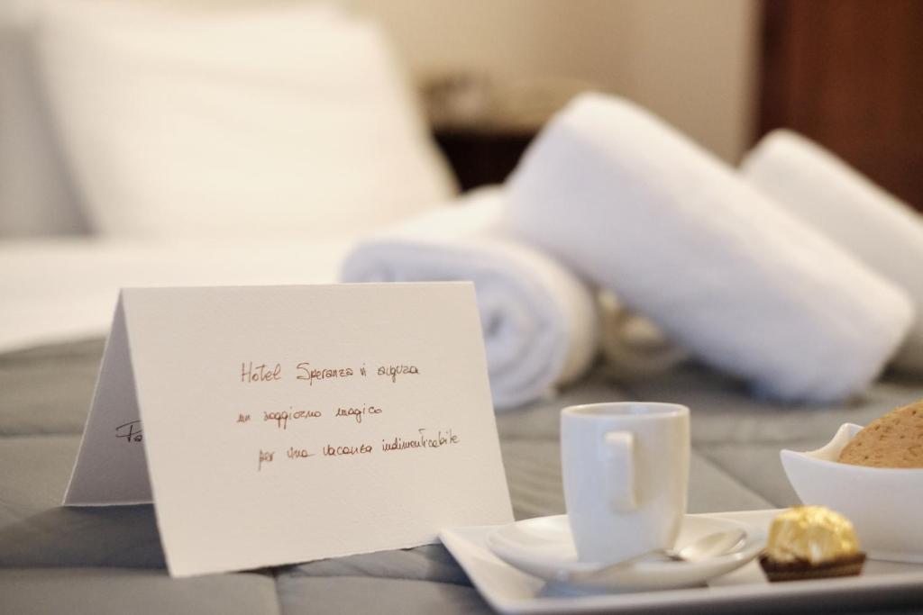 a piece of paper on a table with a cup and saucer at Albergo Trattoria Speranza in Foza