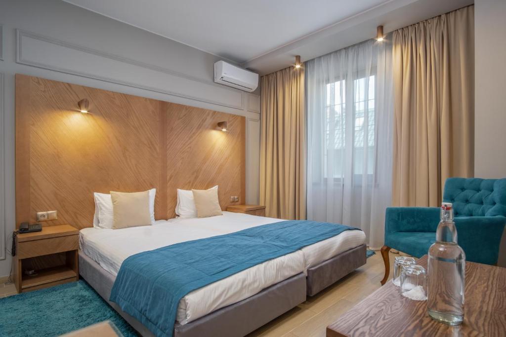 Postel nebo postele na pokoji v ubytování Boomerang Boutique Hotel