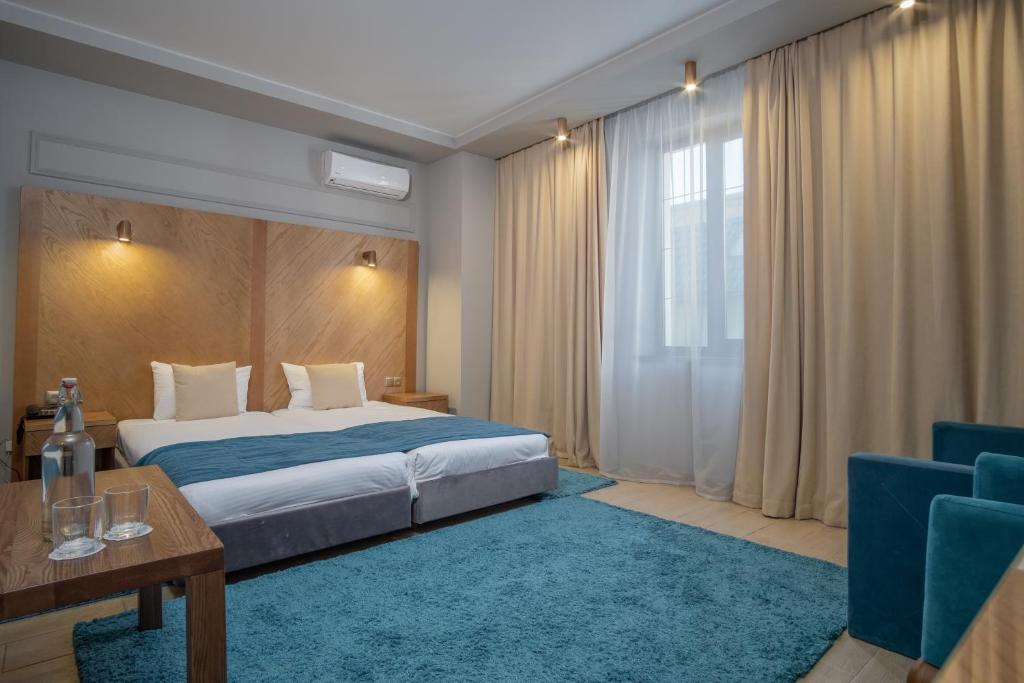 Postel nebo postele na pokoji v ubytování Boomerang Boutique Hotel