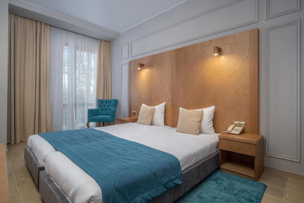Postel nebo postele na pokoji v ubytování Boomerang Boutique Hotel