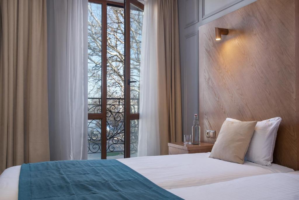Postel nebo postele na pokoji v ubytování Boomerang Boutique Hotel