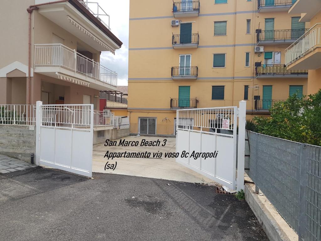 a sign on a fence in front of a building at San Marco Beach App Libeccio in Agropoli