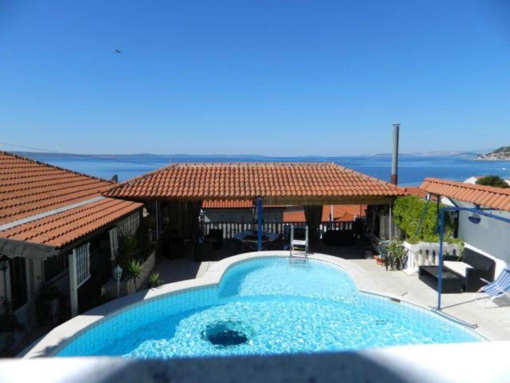 a swimming pool with a view of the ocean at Villa Elit in Dugi Rat