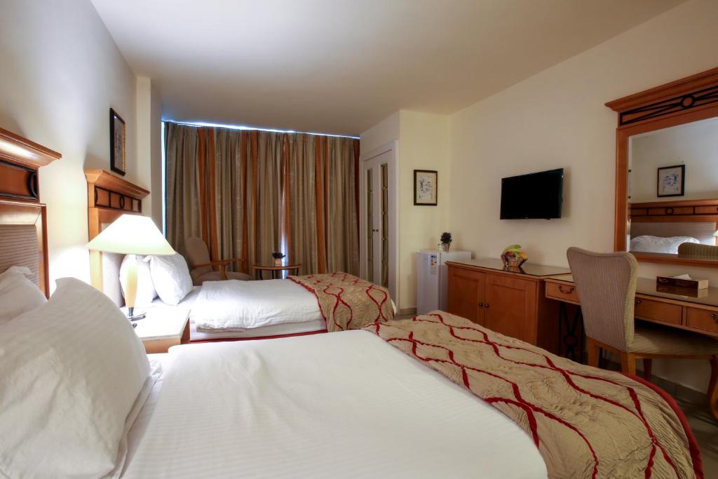 Postel nebo postele na pokoji v ubytování Mina Hotel