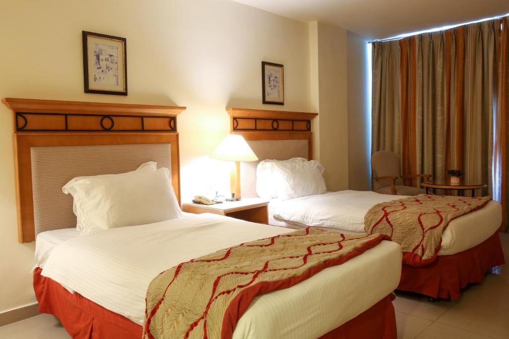 Postel nebo postele na pokoji v ubytování Mina Hotel