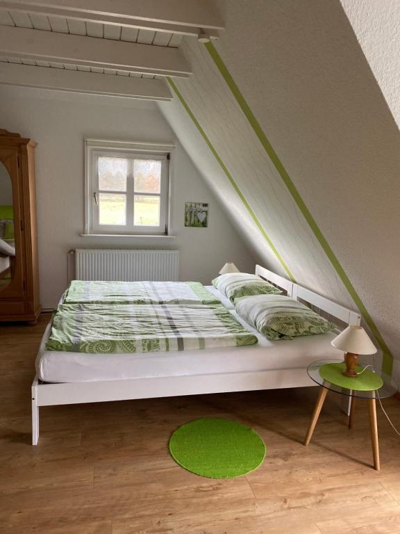 a white bed in a room with a window at Landhaus Kiesow in Suderburg