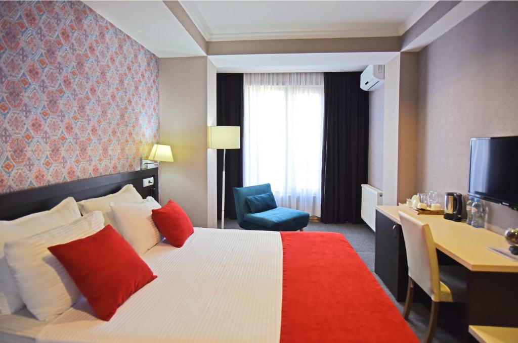 Postel nebo postele na pokoji v ubytování East Gate Boutique Hotel