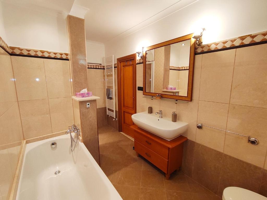 a bathroom with a tub and a sink and a bath tub at Apartment da Rosa in San Vito dei Normanni