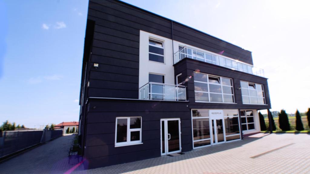 a black and white building with a lot of windows at Wesoła Apartamenty in Wólka Kosowska