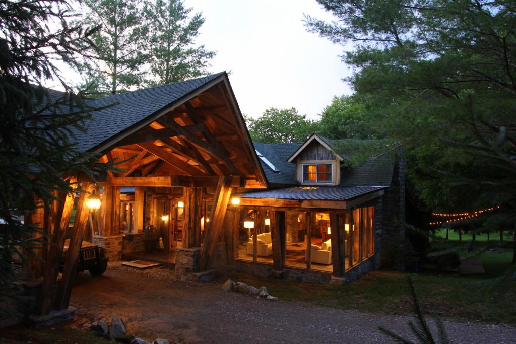 una casa de madera con techo de gambrel en Enchanting Chalet, Covered Parking, King Suite, en Franklin