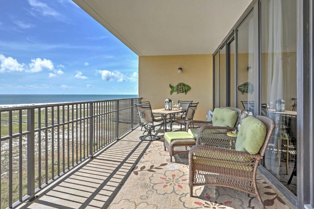 a balcony with chairs and a table and the ocean at Beachfront Bliss on Dauphin Island with Pool Access! in Dauphin Island