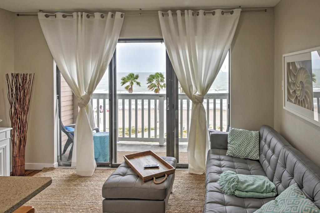 a living room with a couch and a view of the ocean at Beachfront Corpus Christi Condo with Deck and Views! in Corpus Christi