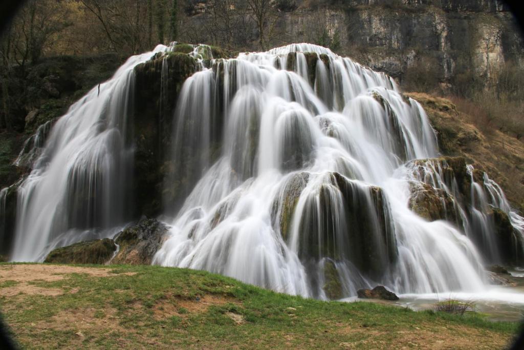 a waterfall in the middle of a field at le refuge des Marmottes in Saint-Laurent-du-Jura
