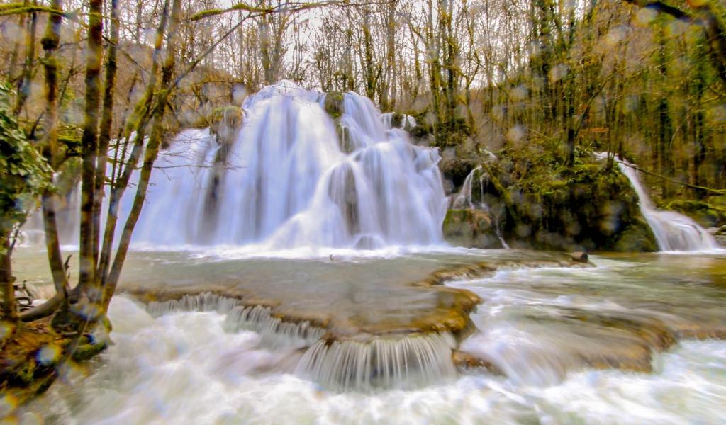 a waterfall in the middle of a river at le refuge des Marmottes in Saint-Laurent-du-Jura