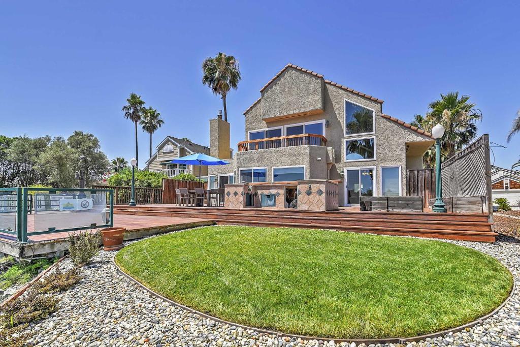 a house with a large backyard with a grassy yard at Waterfront Discovery Bay Home Outdoor Bar and Dock in Discovery Bay