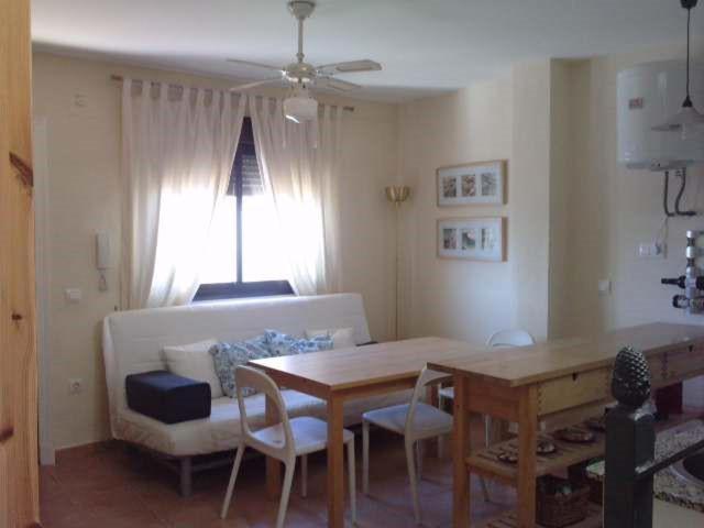 a living room with a table and a couch at Apartamentos Patrisol in Zahara de los Atunes