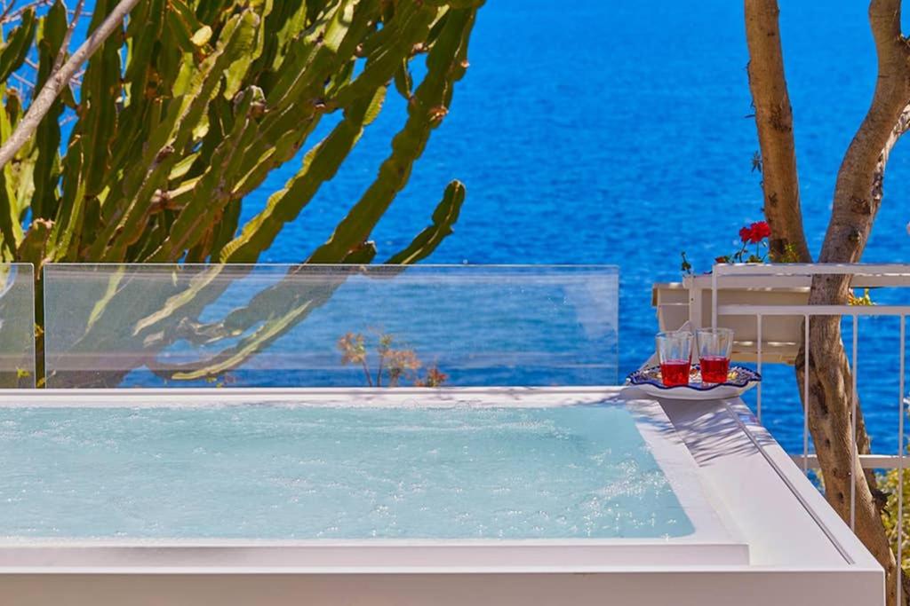 a swimming pool with a view of the ocean at Casa Mamà private access to sea in Santa Flavia