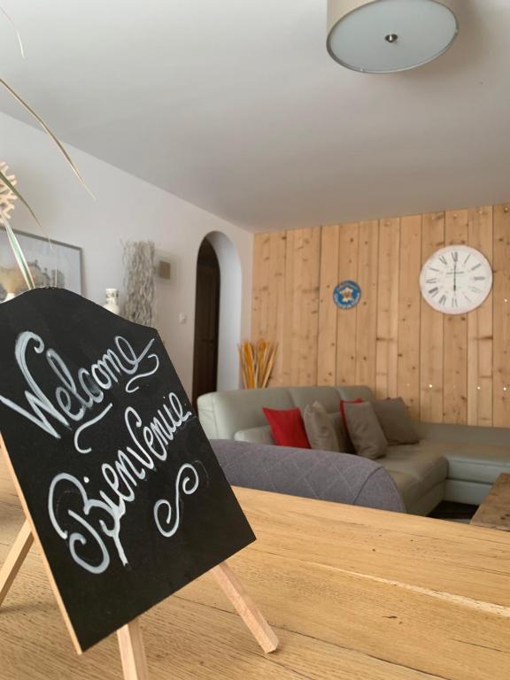 a chalkboard sign sitting in front of a living room at Les Hirondelles in Wintzenheim