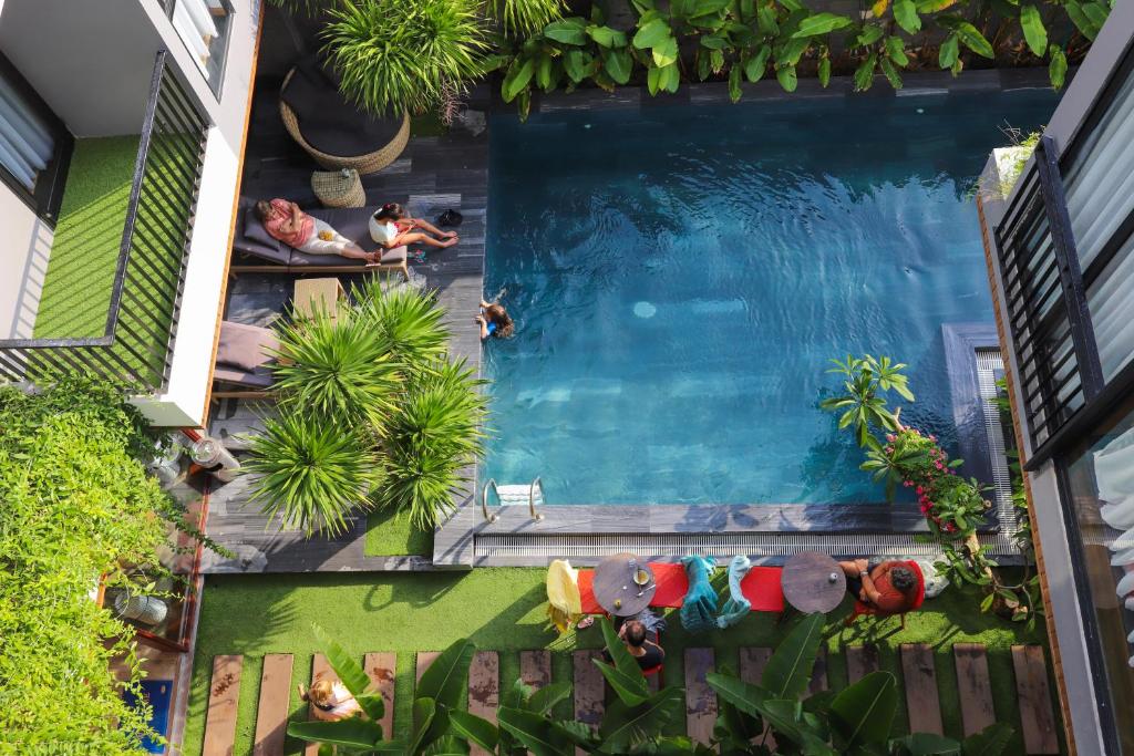 an overhead view of a swimming pool with people swimming at K-House vs Apartment in Da Nang