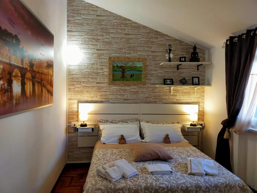 Luxury Apartment Magnolia Terrace في فريجيني: غرفة نوم عليها سرير وفوط
