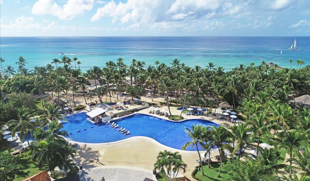 an aerial view of a resort with a pool and the ocean at Catalonia Bayahibe - All Inclusive in Bayahibe