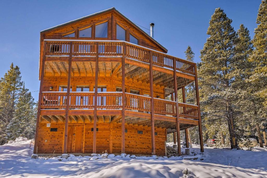 a large log cabin in the snow with a wrap around deck at Fairplay House with Deck and Panoramic Nature Views! in Fairplay