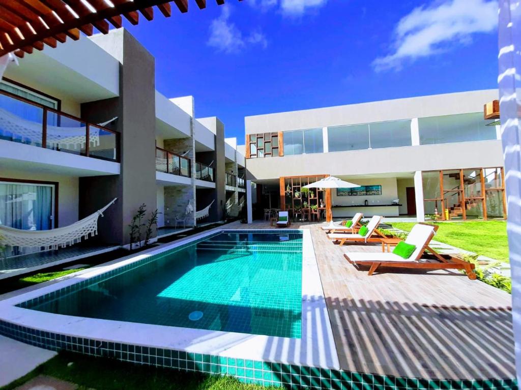 an exterior view of a house with a swimming pool at Pousada Ricoco in São Miguel dos Milagres