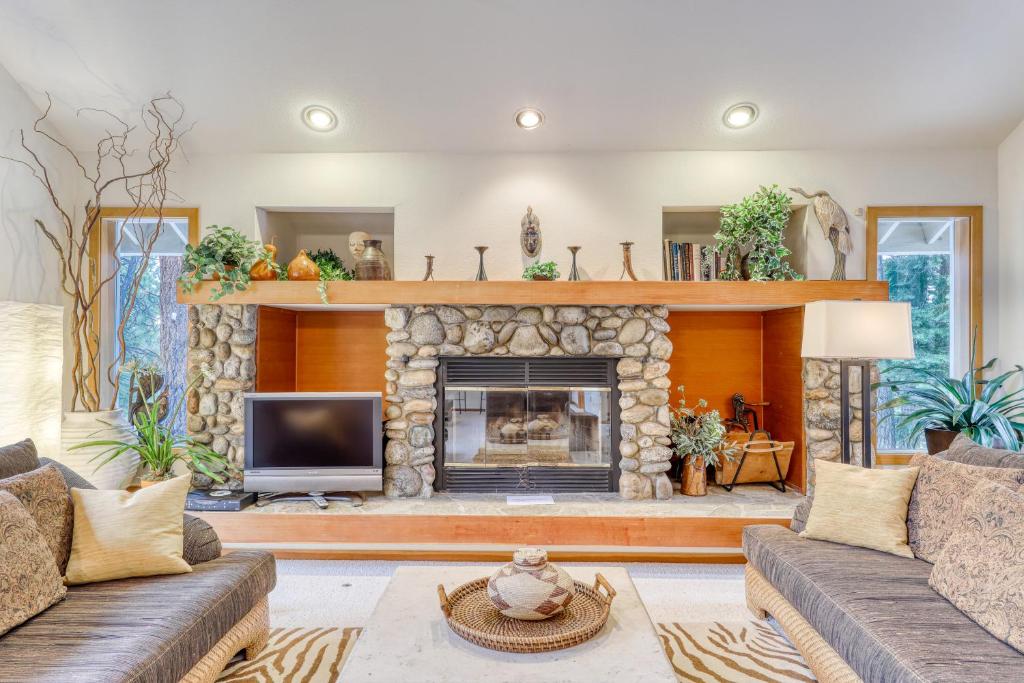 a living room with a large stone fireplace at Belle View in Incline Village