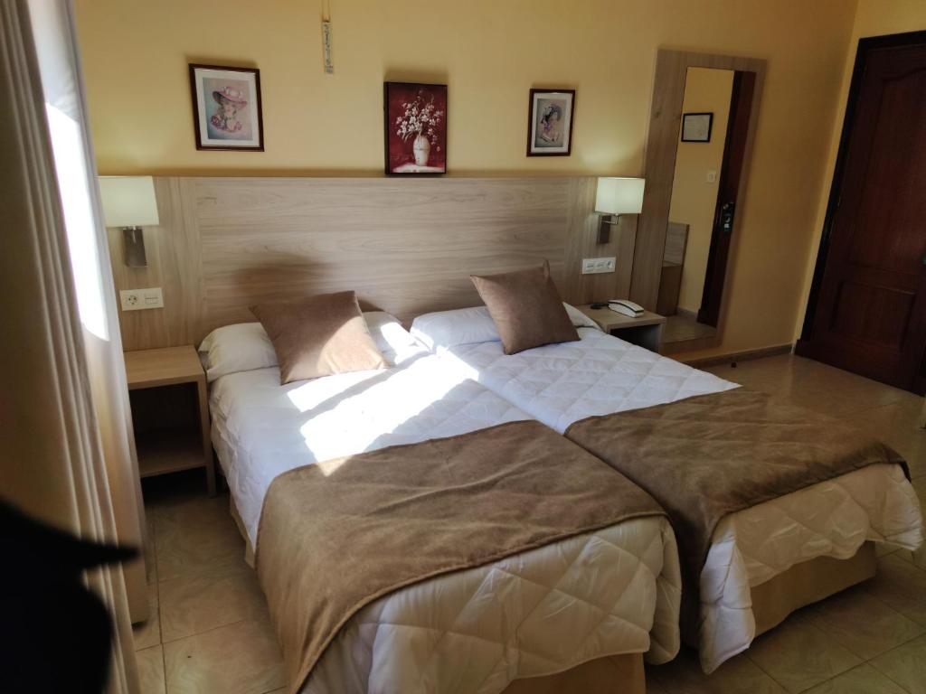 a bedroom with a large bed in a room at Hotel Catalán Puerto Real in Puerto Real