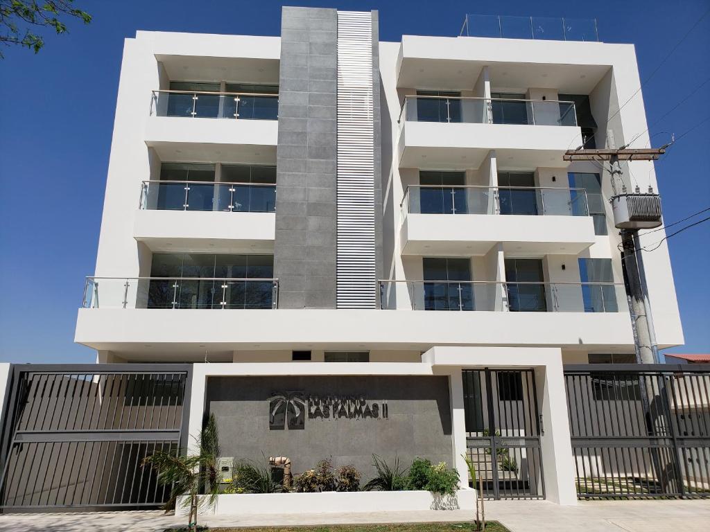 a white building with balconies on the side of it at Condominio Las Palmas II VILLA FATIMA in Santa Cruz de la Sierra