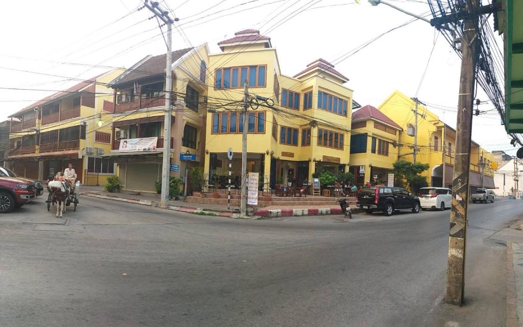 a yellow building on the side of a street at Ban Mae Boonthong in Lampang