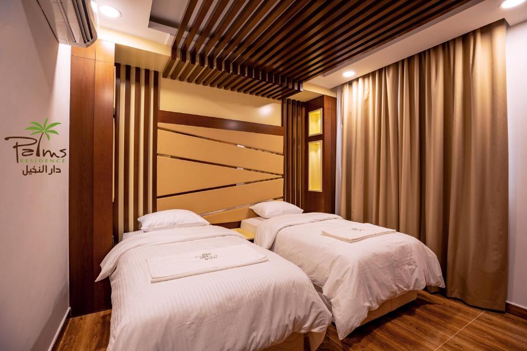 Postel nebo postele na pokoji v ubytování Palms Residence Inn دار النخيل
