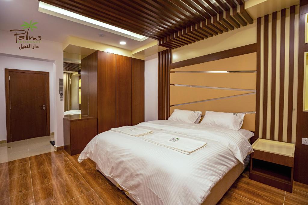 Postel nebo postele na pokoji v ubytování Palms Residence Inn دار النخيل